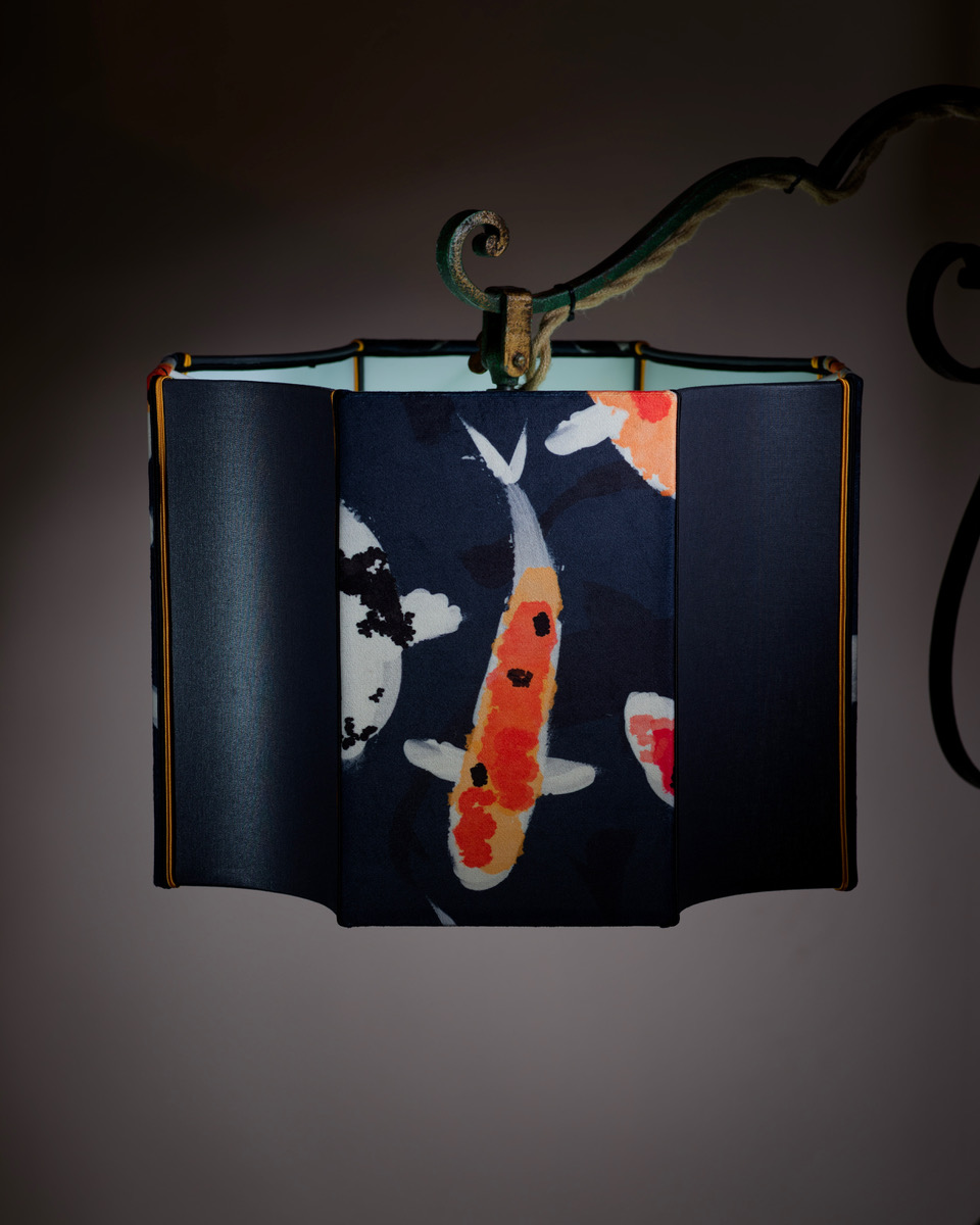 Mailed Lantern Hanging By a Green and Brown Wpective Clip with an Open Top Chapter containing Light Green and marine blue ...